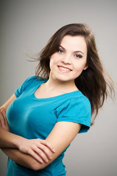 Attractive young woman in a blue shirt. Woman standing with fold — Stock Photo, Image