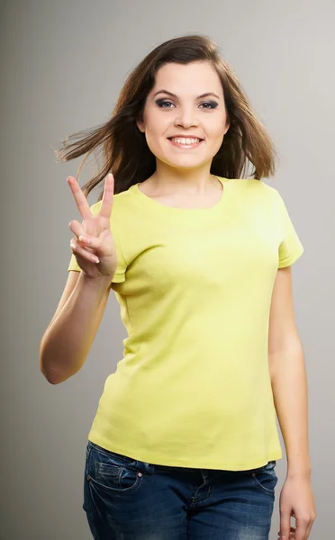 Jolie jeune femme en chemise jaune. Femme montre un symbole o — Photo