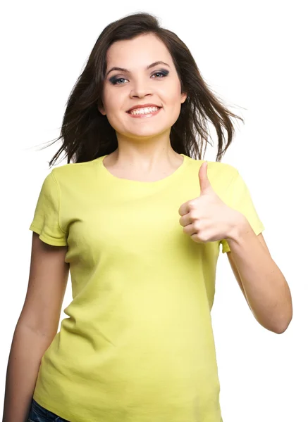 Atraktivní mladá žena ve žluté košili. žena ukazuje palce u — Stock fotografie