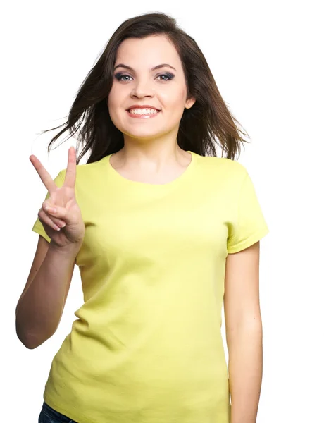 Attractive young woman in a yellow shirt. Woman shows a symbol o — Stock Photo, Image