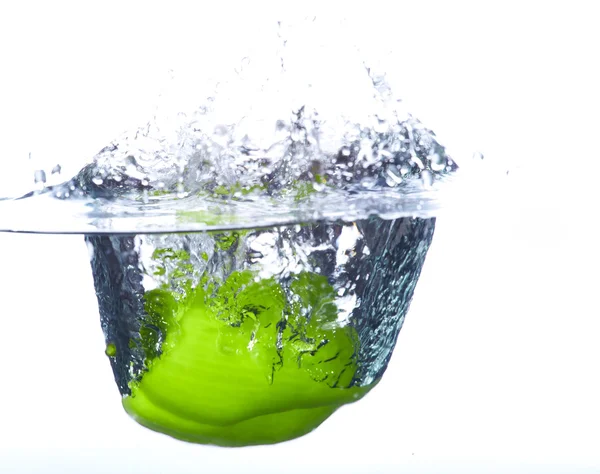 Fresh green paprika falling into the water with a splash of wate — Stock Photo, Image