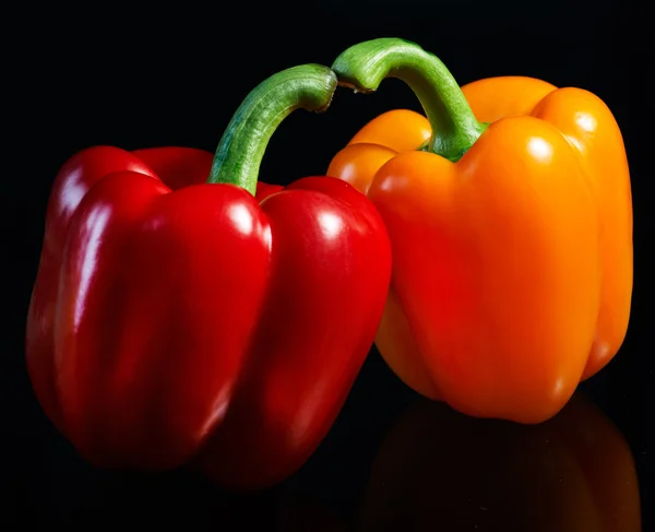 Two fresh peppers. On a black background — Stock Photo, Image