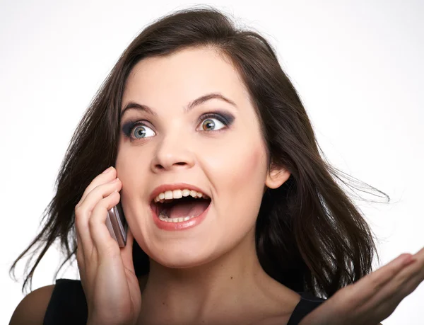 Portrait of a surprised young woman in a gray dress. Woman talki — Stock Photo, Image