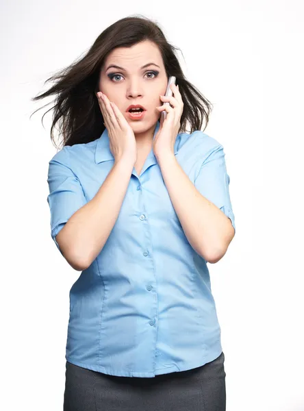 Surprised young woman in a blue blouse. Woman talking on a mobil — Stock Photo, Image