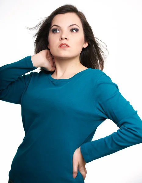 Attractive young woman in a blue shirt. Looking into the upper-r — Stock Photo, Image