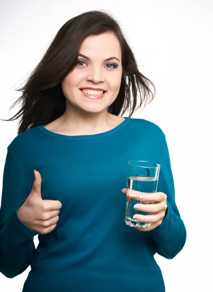 Attractive young woman in a blue shirt. Woman holding a glass of — Stock Photo, Image