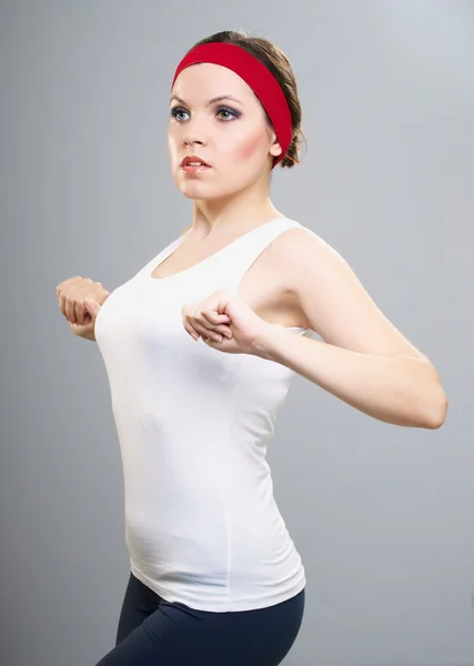 Attractive young woman in a white T-shirt. Woman doing exercise. — Stock Photo, Image