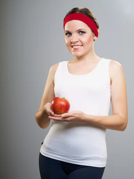 Attractive young woman in a white T-shirt. Woman holds a red app — Stock Photo, Image