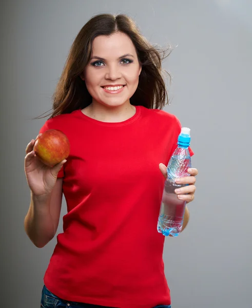 Attractive young woman in a red shirt. Woman holding a bottle of — Stock Photo, Image