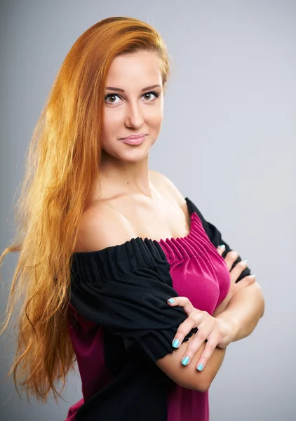 Attractive young woman with long red hair in a red dress. — Stock Photo, Image