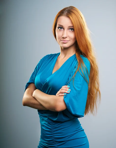 Attractive young woman with long red hair in a blue dress. — Stock Photo, Image