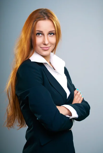 Attractive young woman in a black jacket. Standing with folded h — Stock Photo, Image