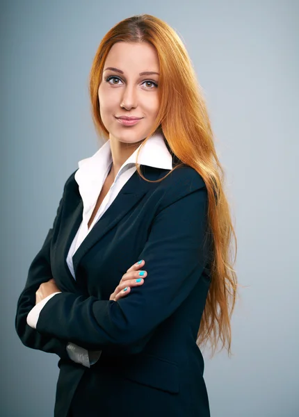 Attractive young woman in a black jacket. Standing with folded h — Stock Photo, Image