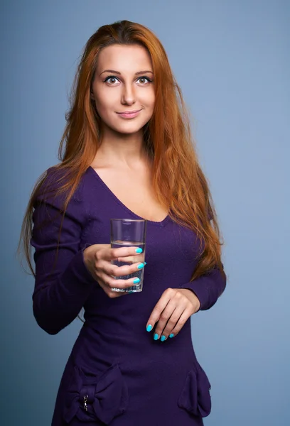 Attractive young woman in a lilac dress. Holding a glass of mine — Stock Photo, Image