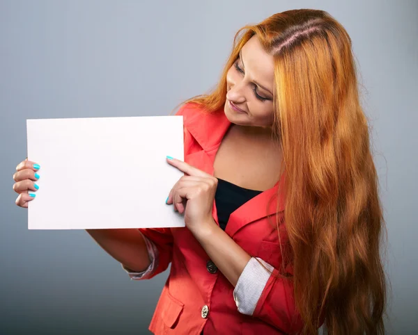 Attractive young woman in a red jacket. Holds a poster and looki — Stock Photo, Image