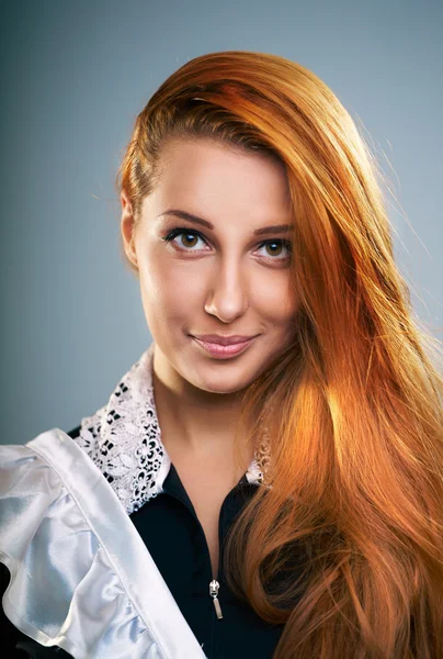 Attractive young woman in a school uniform. Long red hair. — Stock Photo, Image