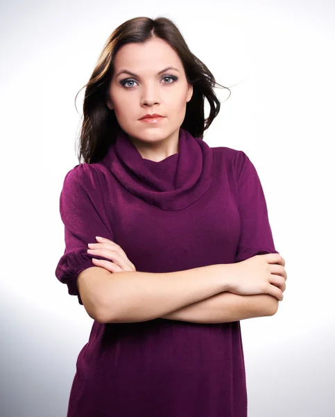 Attractive young woman in a purple dress. — Stock Photo, Image