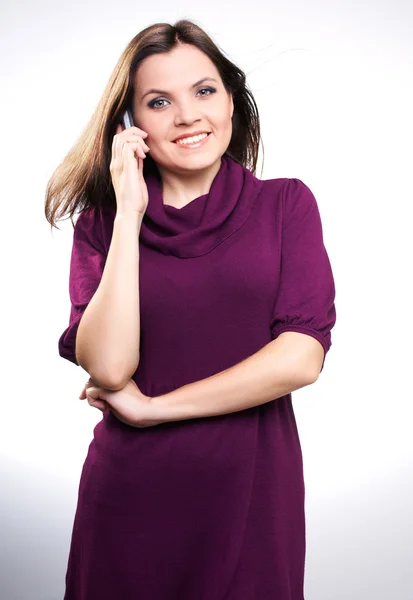 Attractive young woman in a dress. Woman talking on a mobile pho — Stock Photo, Image