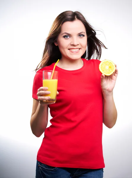 Young beautiful girl in a red shirt holding in one hand an orang — Stock Photo, Image