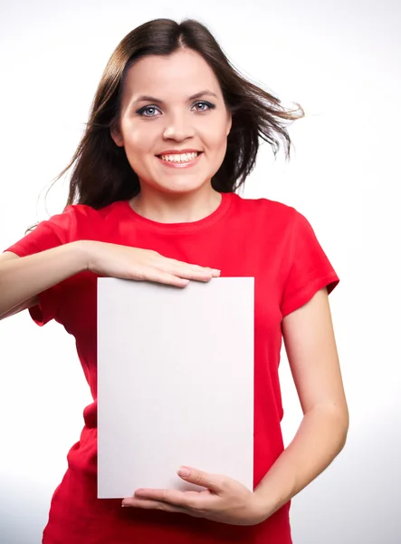 Attractive smiling girl in red shirt holding a poster. — Stock Photo, Image