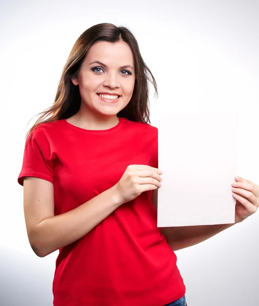 Attractive smiling girl in red shirt holding a poster. — Stock Photo, Image