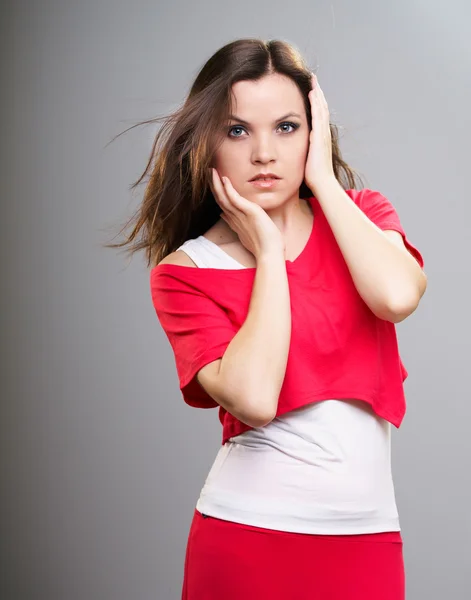 Attractive young woman in a red shirt and skirt. — Stock Photo, Image