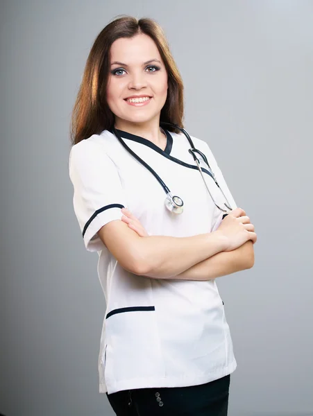 Attractive young nurse. Standing with folded hands. — Stock Photo, Image