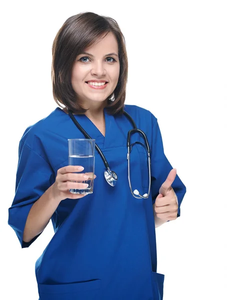 Attractive young nurse with a stethoscope. Holding a glass of mi — Stock Photo, Image