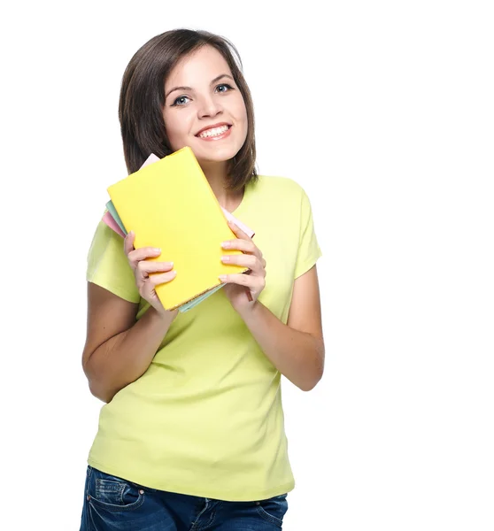 Happy young woman in a yellow shirt. Holds a the books. — Stock Photo, Image