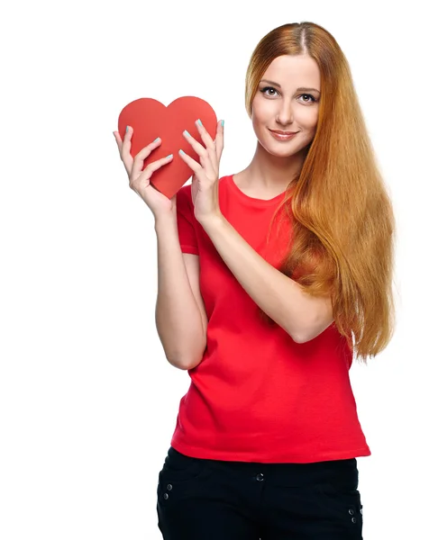 Attractive young woman in a red shirt. Holding red heart. — Stock Photo, Image