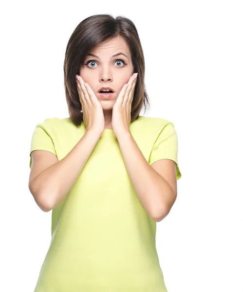 Surprised young woman in a yellow shirt. — Stock Photo, Image