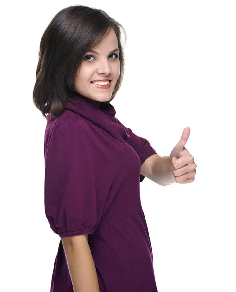 Attractive young woman in a red dress. Showing thumbs up. — Stock Photo, Image