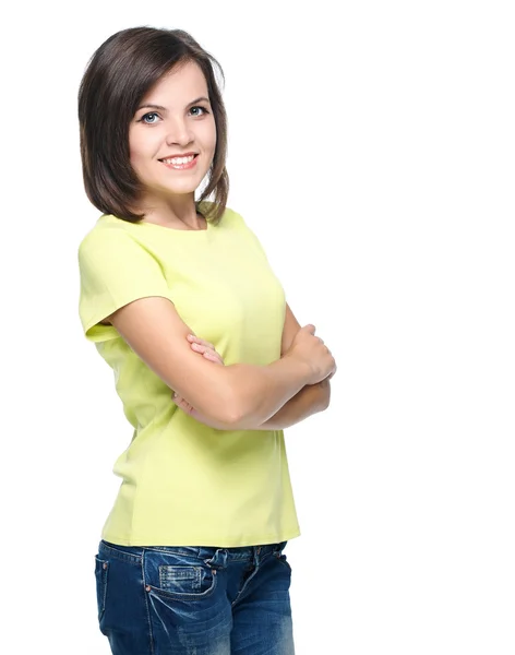 有魅力的年轻女人在黄色的衬衫和蓝色牛仔裤。站 — 图库照片