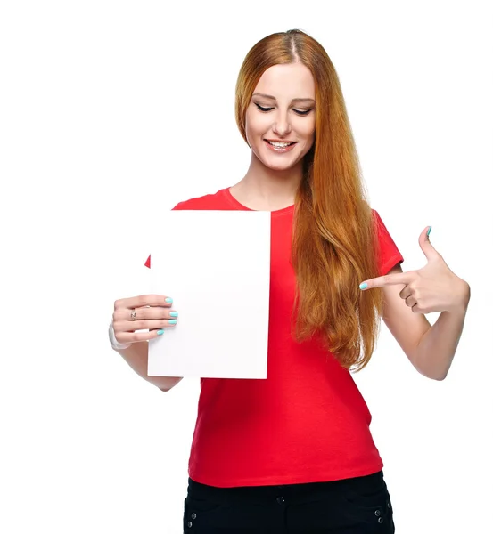 Attractive young woman in a red shirt. Holds a poster and points — Stock Photo, Image