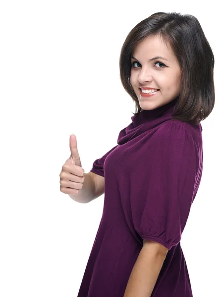 O femeie tânără atractivă într-o rochie roșie. Arată degetele mari în sus . — Fotografie, imagine de stoc