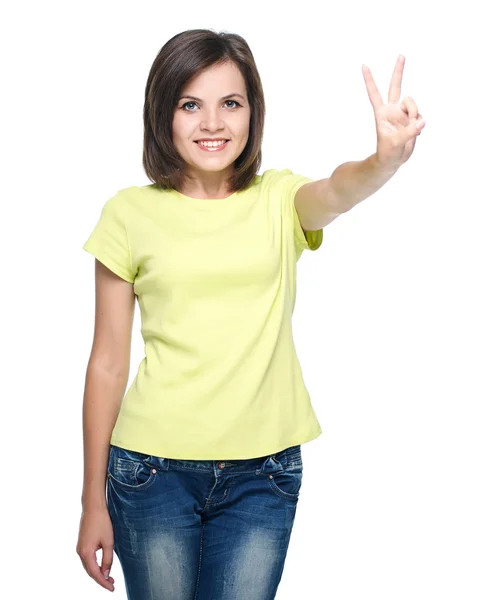 Atractiva joven con camisa amarilla y vaqueros azules. Muestra t — Foto de Stock