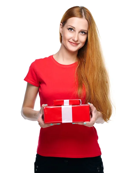 Attractive young woman in a red shirt. Holds a red gift box. — Stock Photo, Image