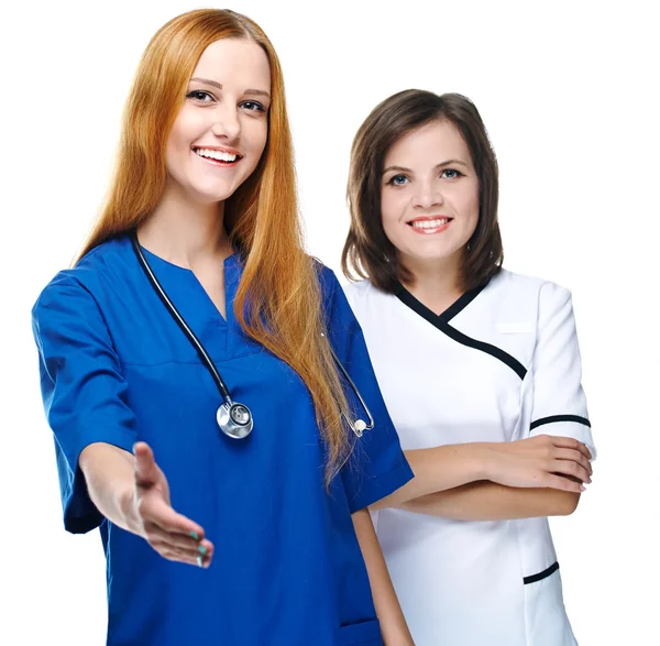 Two attractive nurses in uniform. A nurse gives a hand for a han — Stock Photo, Image