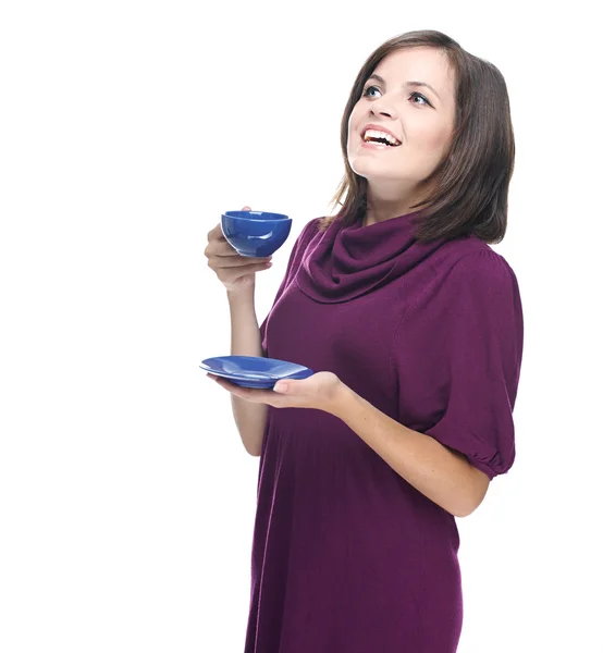 Attractive young woman in a red dress. Holds a blue cup and sauc — Stock Photo, Image