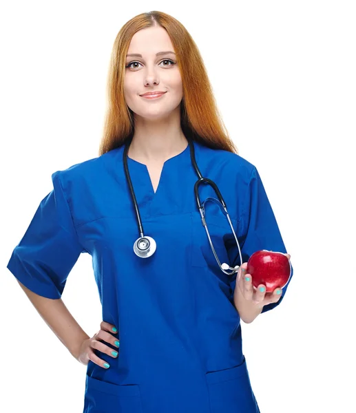 Attractive young nurse in uniform. Holds red apple. Isolated on — Stock Photo, Image