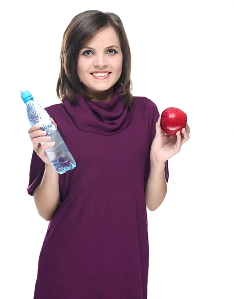 Attractive young woman in a red dress. Holding a bottle of miner — Stock Photo, Image