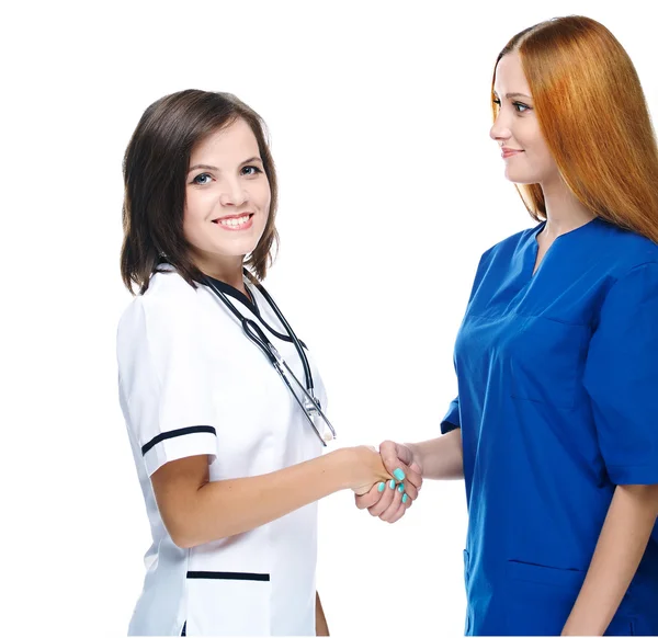 Two attractive nurse shake hands. Isolated on white background — Stock Photo, Image