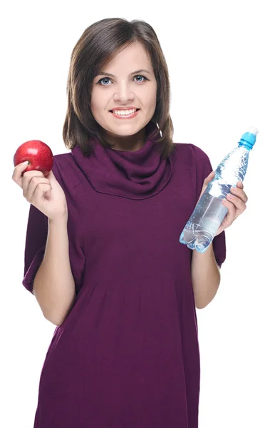 Attractive young woman in a red dress. Holding a bottle of miner — Stock Photo, Image