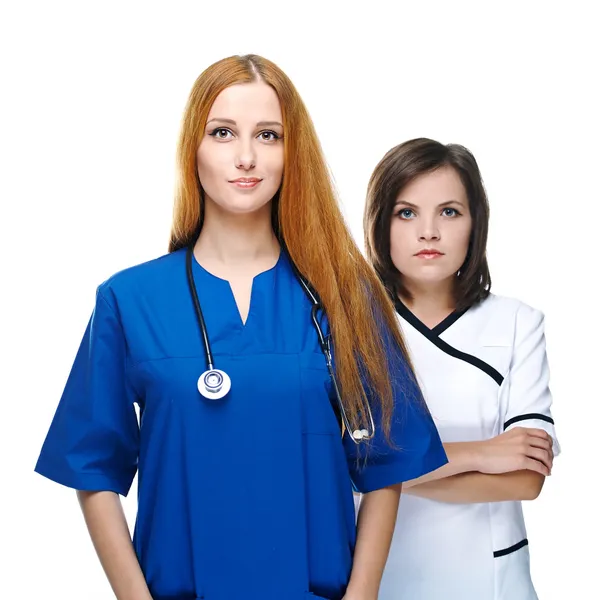 Two attractive nurses in uniform. Isolated on white background — Stock Photo, Image