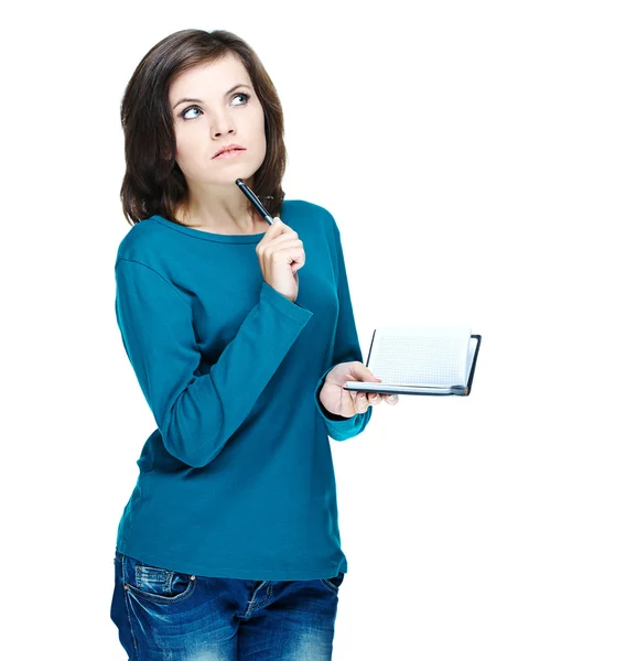 Attraktiva flicka i en blå tröja som håller en anteckningsbok och skriver som — Stockfoto