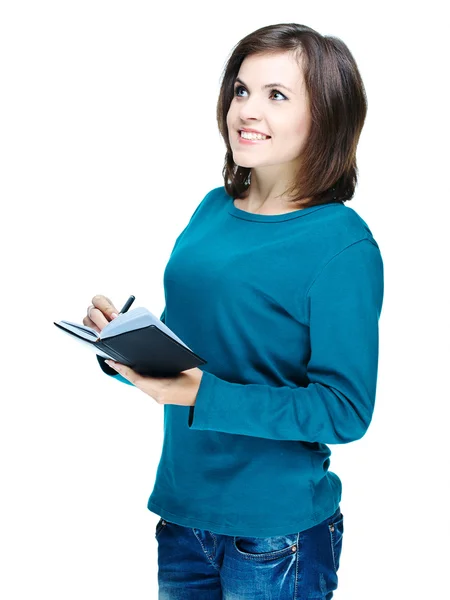 Ελκυστικό χαμογελαστό κορίτσι σε ένα μπλε πουκάμισο, κρατά ένα σημειωματάριο και w — Φωτογραφία Αρχείου