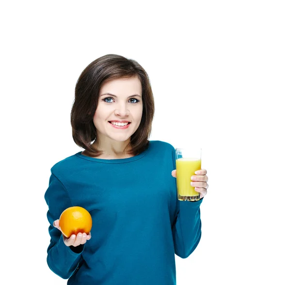 Happy young smiling girl in a blue shirt. Holding a glass of jui — Stock Photo, Image