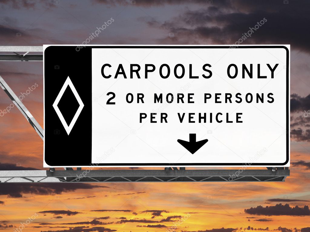 Overhead Freeway Carpool Only Sign with Sunset Sky