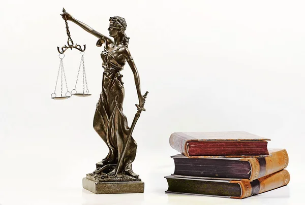 Justice figure and old books on a white background. Justice, scales, court