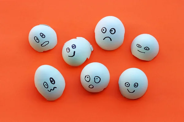 Eggshells with painted faces with different emotions